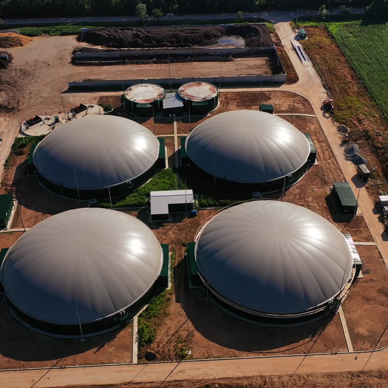 Production of green energy from biomass. Modern factory for organic fuel production. Circle movement over the biogas plant