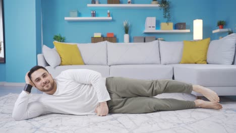 Young-fitness-teacher-doing-leg-stretch-while-smiling-at-camera.