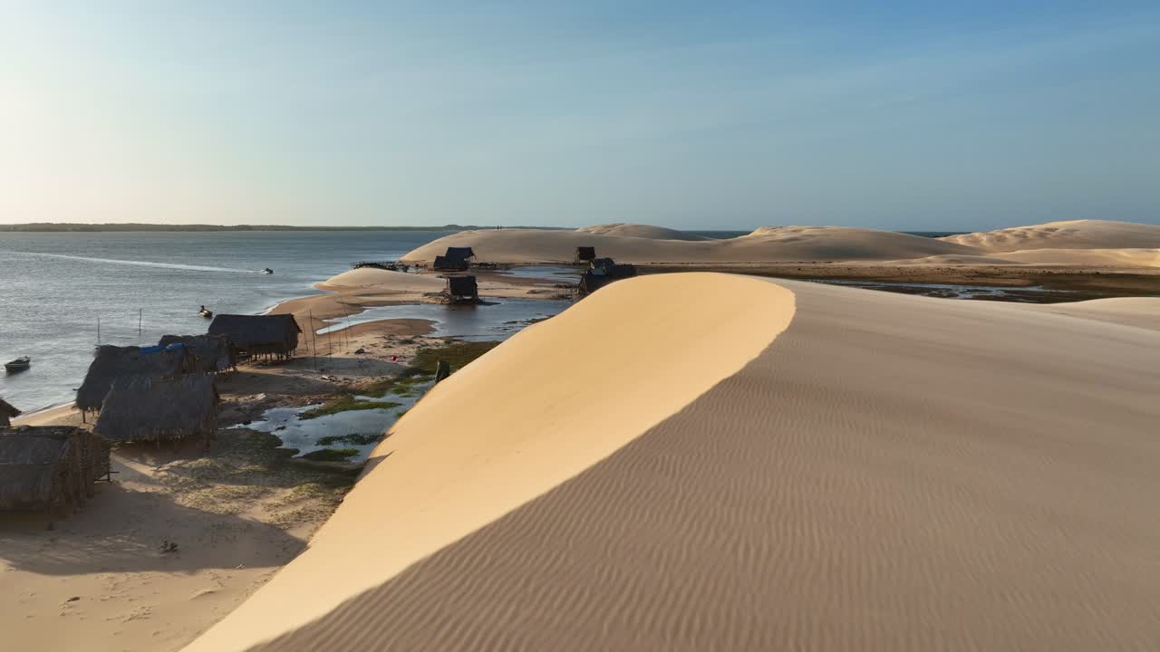 Dune landscape reveals Parnaíba River Delta native people wooden huts and settlements