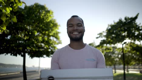happy man holding pizza boxes