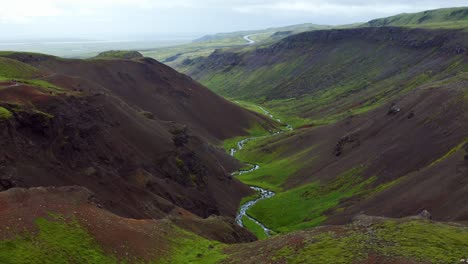 scenic view of mountainscape with hot spring river in reykjadalur, iceland