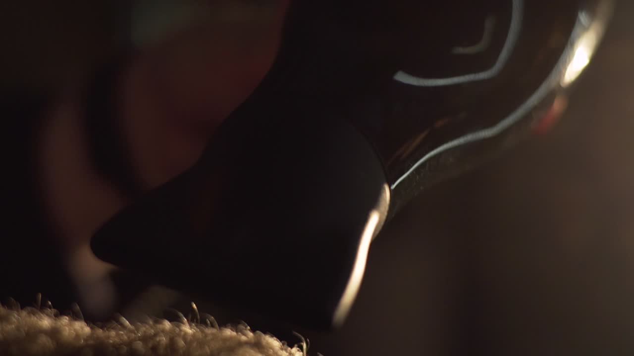 Close-up of a Man with Beard Drying Hair in Low Light