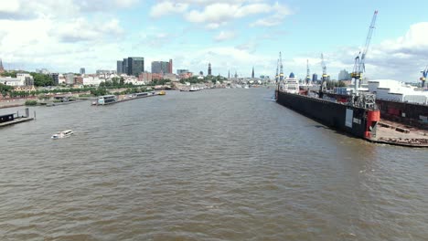 Elbphilharmonie,-River-Elbe-Hamburg,-boat-on-water,-drone-shot