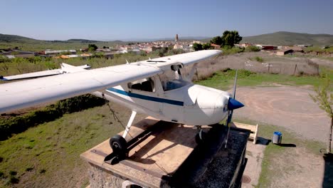 slow 4k drone revealing the small rural village of alcublas with an old cessna 172 as exhibition, spain