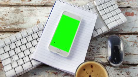 coffee cup, mobile phone, notepad, keyboard, mouse on wooden plank