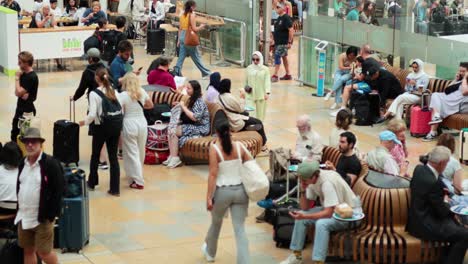 travelers bustling through paddington station in london