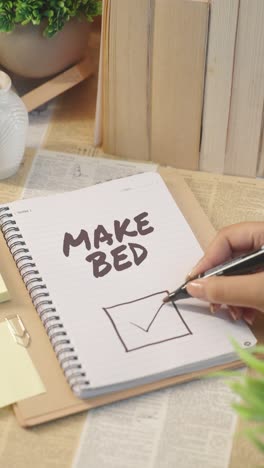 vertical video of ticking off make bed work from checklist