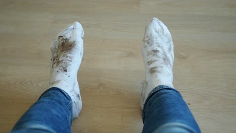 dirty white socks on a wooden floor