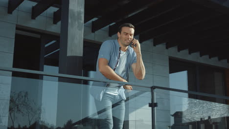 confident man talking phone in modern building. connection lifestyle