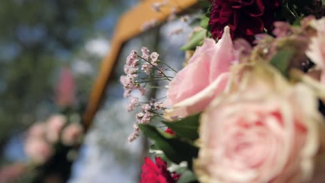 boho decorated hexagonal outdoor wedding ceremony arch detail, defocus closeup