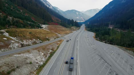 following a semi truck on the coquihalla highway 5 in british columbia canada on a sunny day in the fall