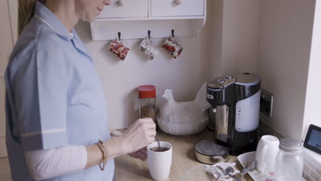 person making coffee in the kitchen