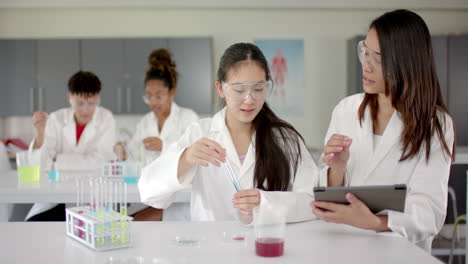 students engage in a science experiment at high school during science class