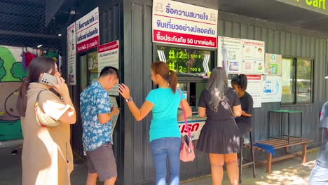 people purchasing tickets at zoo entrance