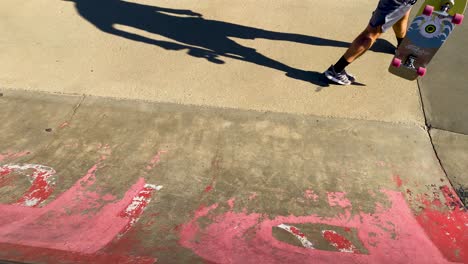 man fails a skateboarding trick on a skatepark ramp