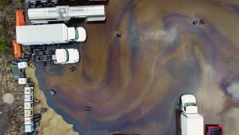 Overhead-Aerial-View-Of-Chemical-Spill-Near-Freight-Vehicles-After-Industrial-Fire