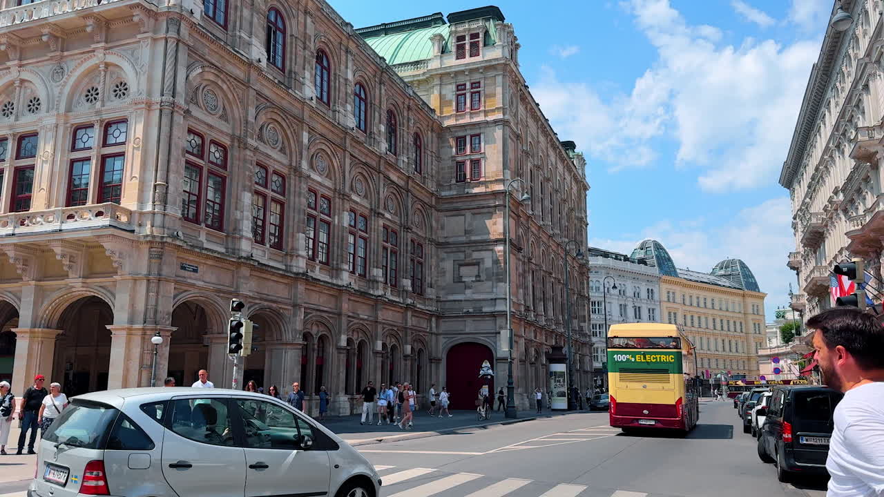 Vienna, Austria - June 9, 2025: Exploring Wien by electric bus tour. Tourists gather around an electric bus in Vienna, Austria, enjoying a sunny day and exploring historic sites