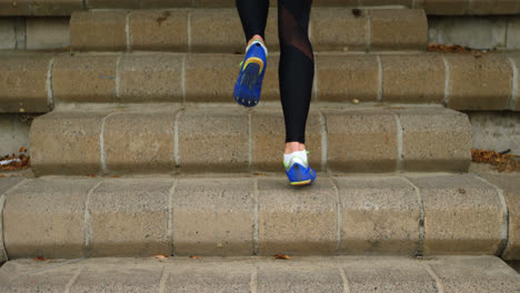 low section of female athlete exercising on steps at sports venue 4k