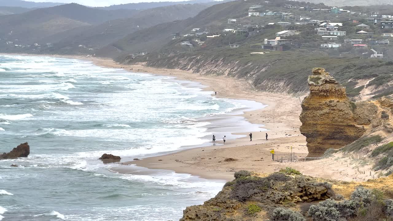 Aerial view of rugged coastline with waves crashing against rocks, capturing the natural beauty of Great Ocean Road, Australia