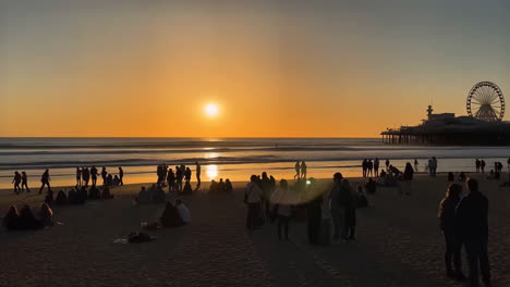 sunset at santa monica beach with pier and people