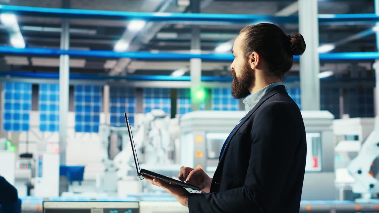 Solar panels plant employee using notebook to track energy production