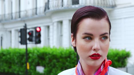 stylish woman wearing scarf standing on city street