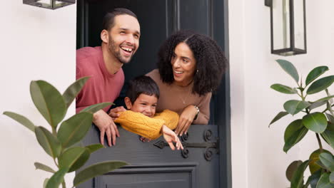 mother, father and child at door of home enjoying