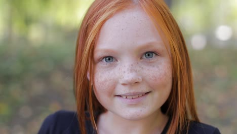 natural appearance of a girl with beautiful freckles on her face teenage girl with blue eyes and freckles on her face looks at the camera close up
