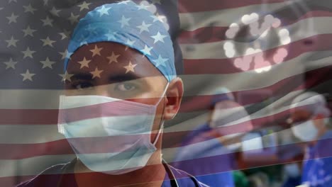 animation of flag of united states of america waving over surgeons in operating theatre