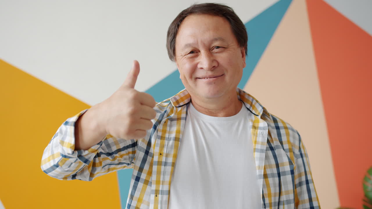 Smiling Asian Man Giving Thumbs Up