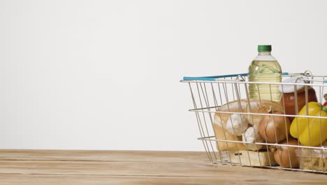 Studio-Shot-Of-Basic-Food-Items-In-Supermarket-Wire-Shopping-Basket-8