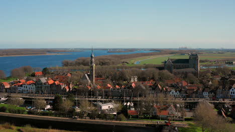 aerial: the historical town of veere with an old harbour and churches, on a spring day