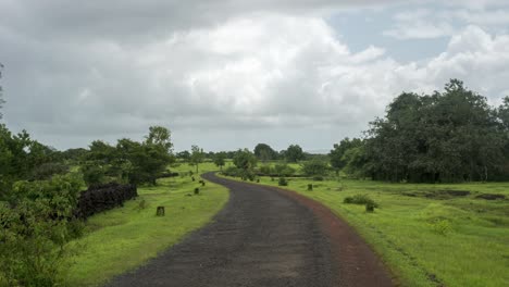 Empty-road-moving-clouds-green-mountain