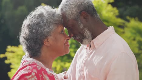 a senior african american couple spending time together in the garden in love in social distancing