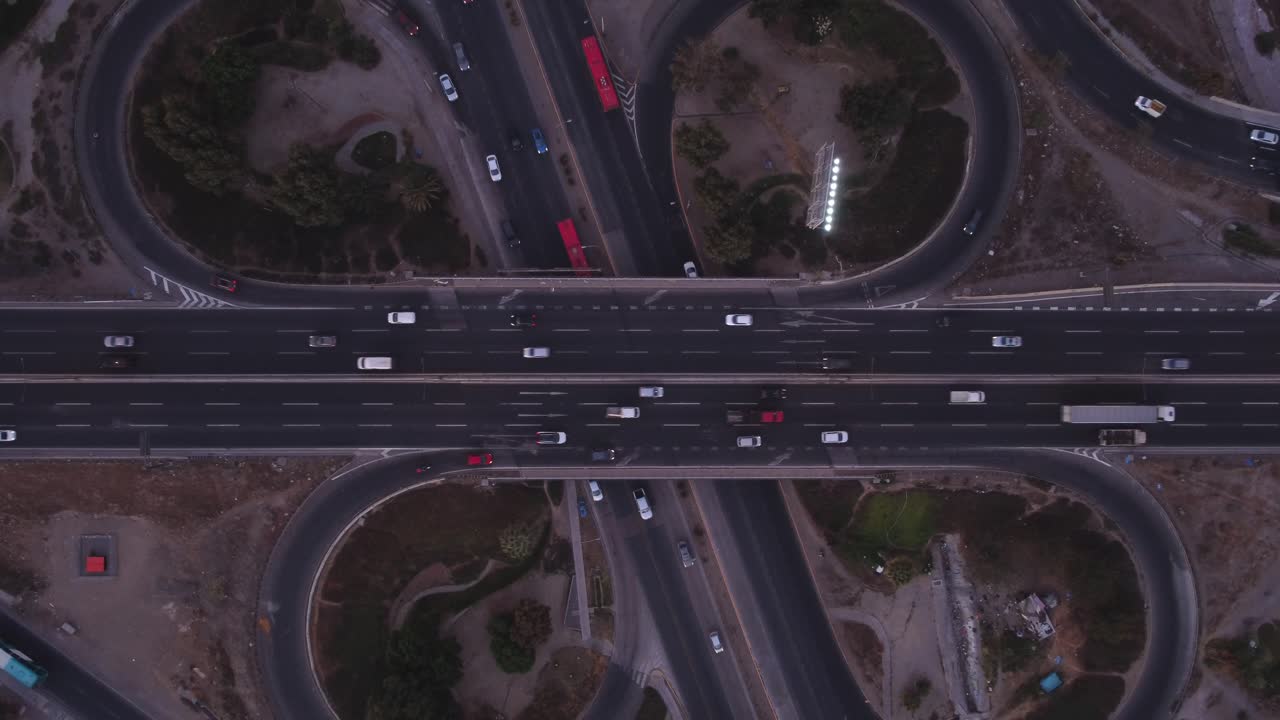Streets and highways connect the city, bohemian nightlife and work. Cars at high speed seen from the air with a drone.