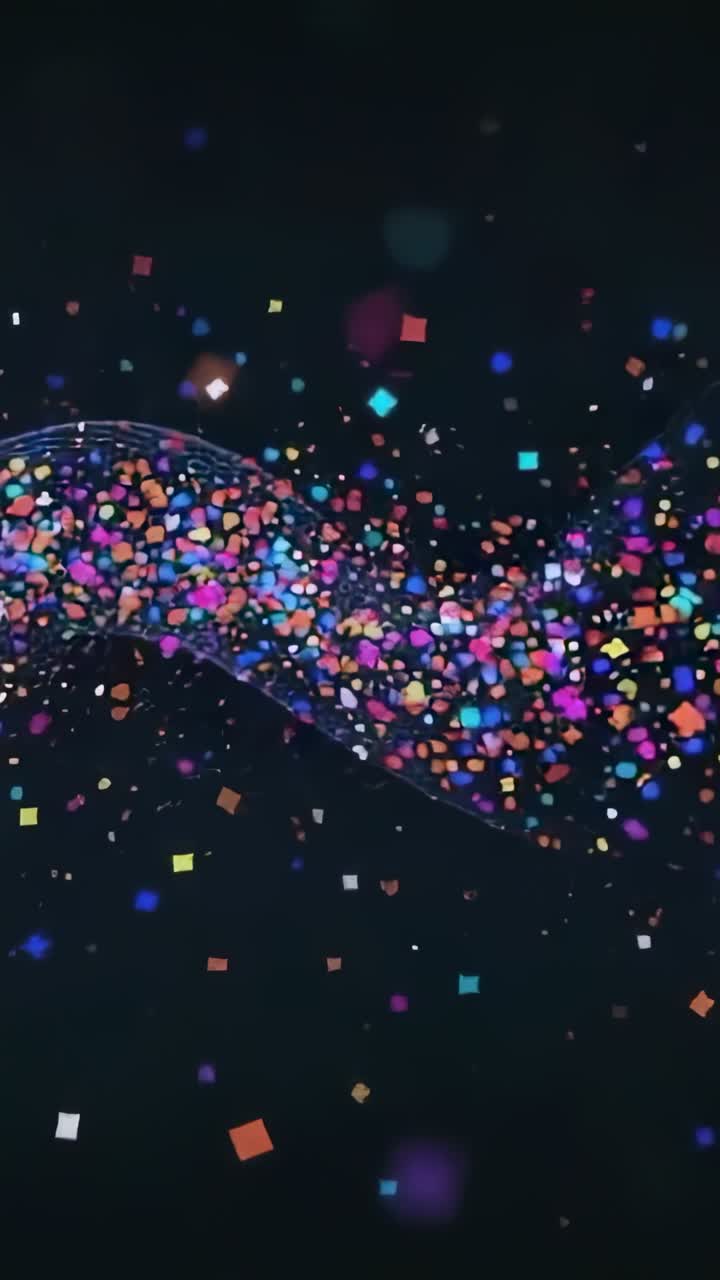 Vertical video: Scattering square particles coalescing into cresting ribbon undulating on dark void