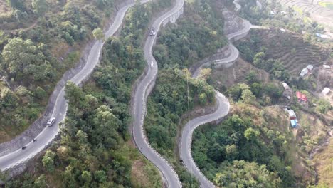 an aerial view of traffic on the bp highway, bardibas highway, showing the switchbacks and turns as it winds through the hills of nepal