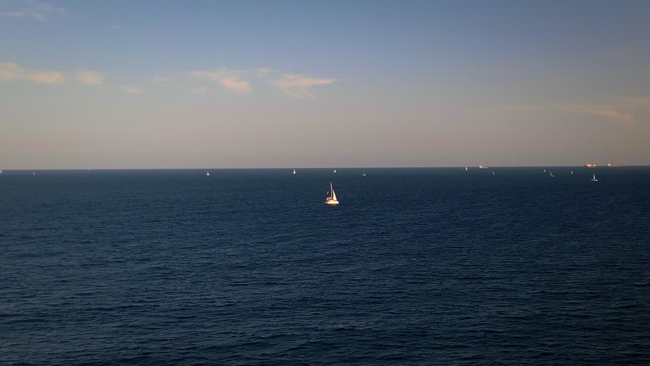 Enjoy the Mediterranean charm of Barcelona with its calm blue waters, sailing boats on the horizon, and clear skies. Perfect for coastal adventures and relaxation.