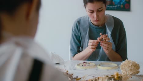 woman creating floral resin art