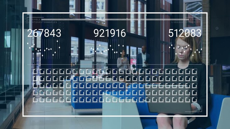 businesswoman typing on laptop in modern business lobby, showing animated finance graphs rising