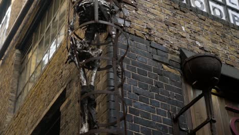 a captivating sculpture of a skeleton in a cage on a building exterior