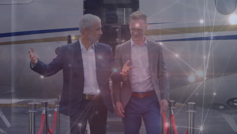 animation of network of connections over diverse business people at airport