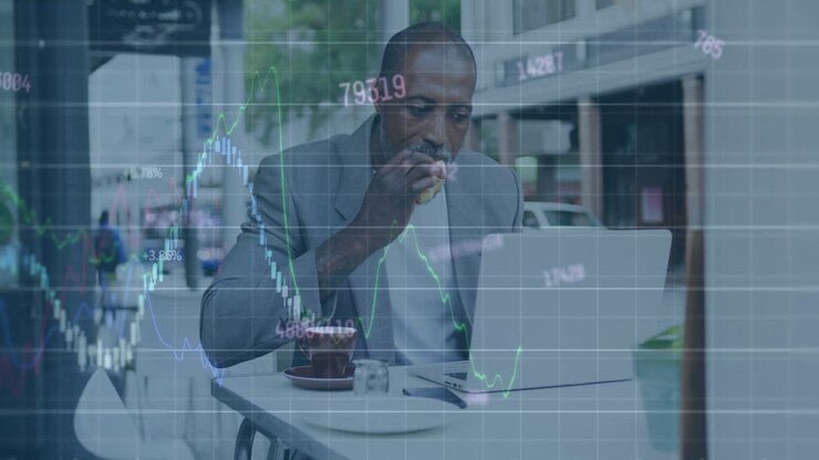 Animation of graphs, numbers, senior african american man with laptop eating breakfast in cafes