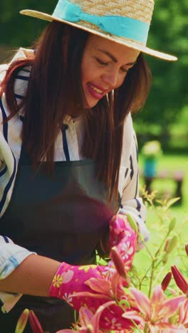 a gardener enjoying the beauty of lilies: captivating moments in blooming flowers with pink gloves and a sun hat