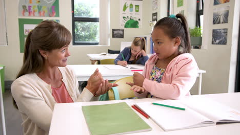 in school, teacher smiling with child, fostering positive classroom environment