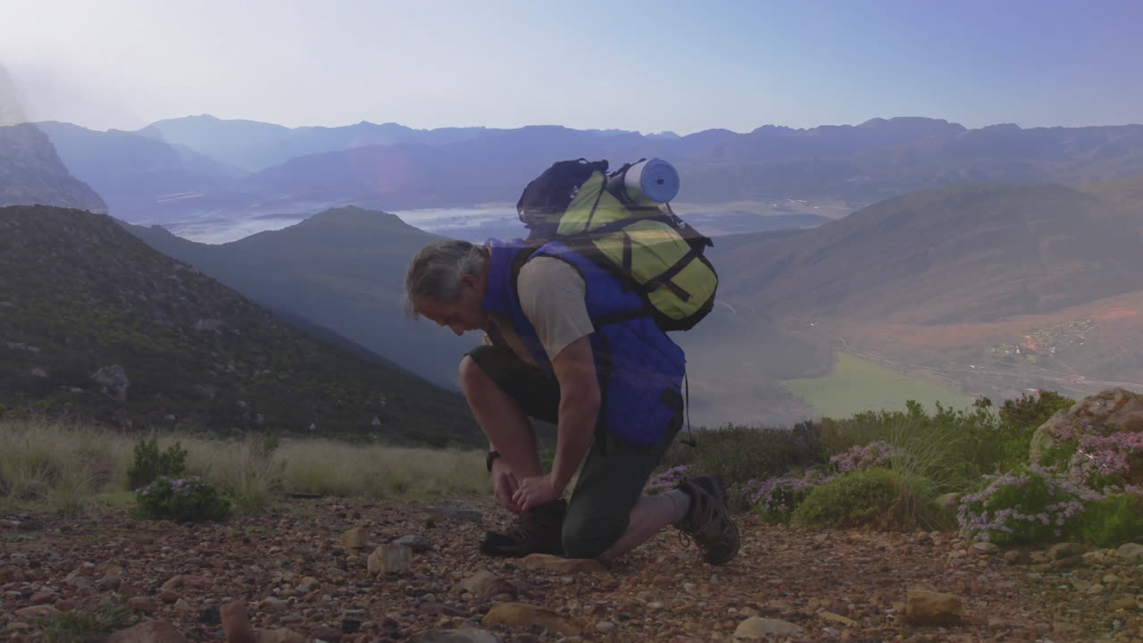 Male hiker kneeling tying boot on rocky trail, with animated health tracker overlay