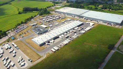 Aerial-view-of-warehouse-storages-or-industrial-factory-or-logistics-center-from-above