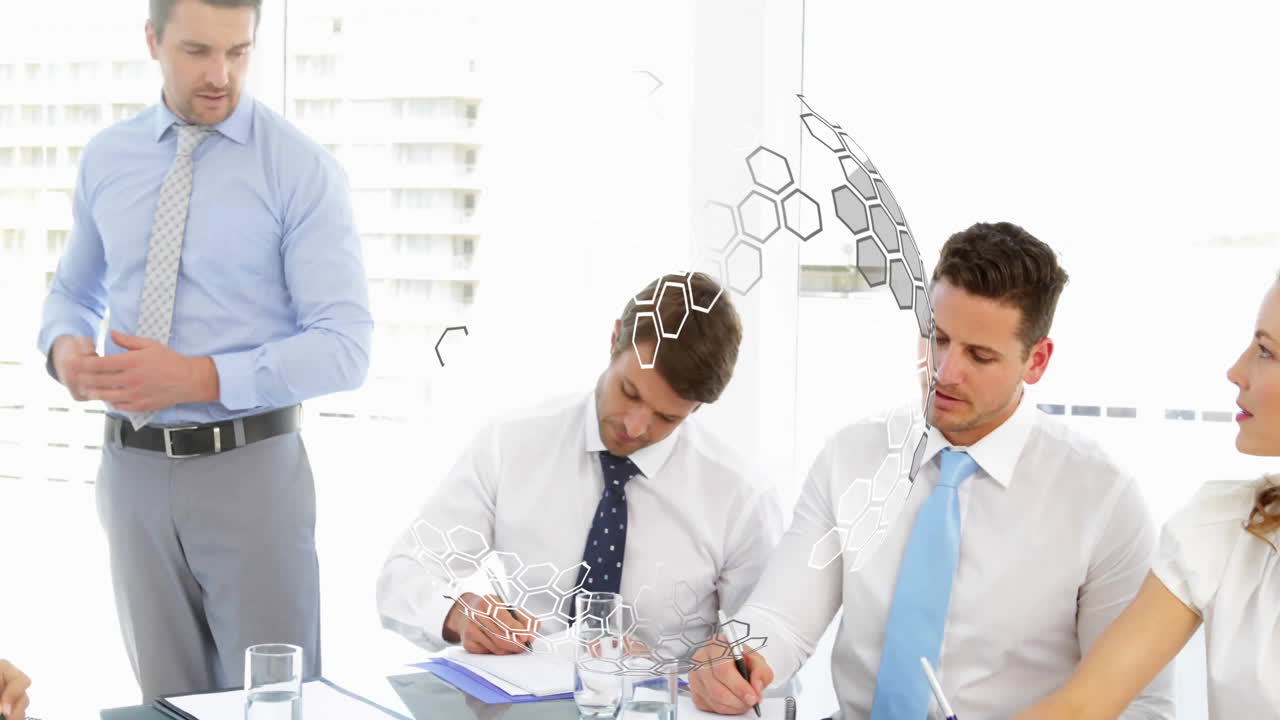 Collaborating in meeting, diverse professionals with digital hexagonal animation overlay