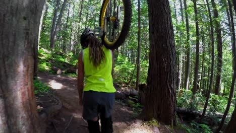 Woman-carrying-unicycle-and-passing-through-the-forest-4k