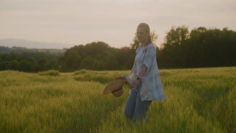 beautiful happy woman enjoying sunset and dancing in meadow